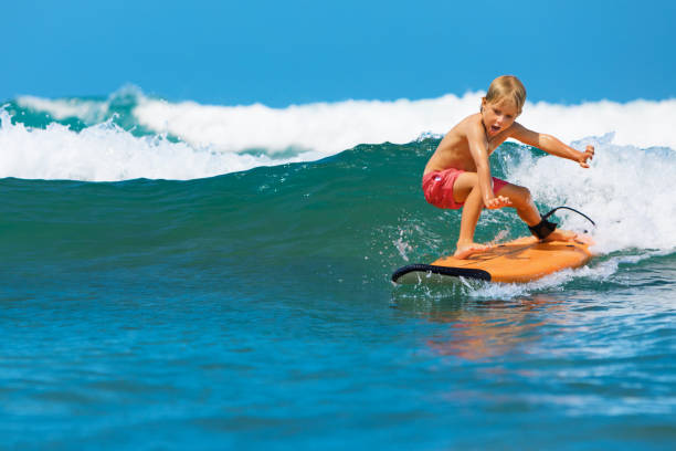 istock Young surfer learn to ride on surfboard on sea waves 1200840169