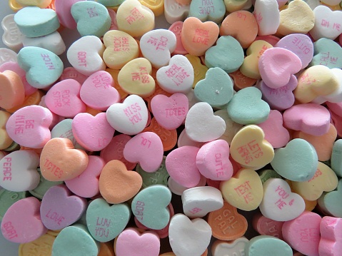 Heart-shaped conversation candies, background, copy space