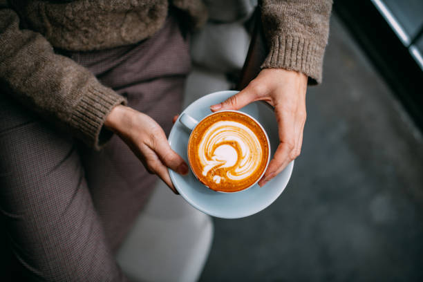 istock Flat Lay Woman Hand Holding Coffee Latte 1200842513