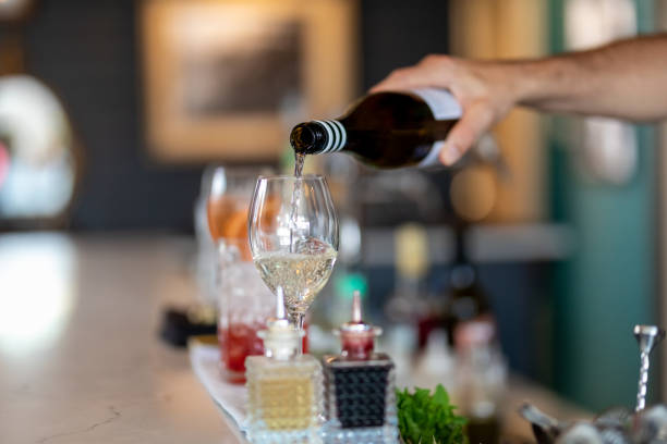 istock Bartender Pouring A Glass Of White Wine 1200845571