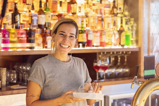 Female Bartender Making Cocktails in Australian bar