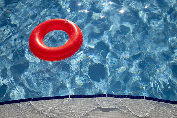 istock floating orange ring on edge of swimpool 120084785