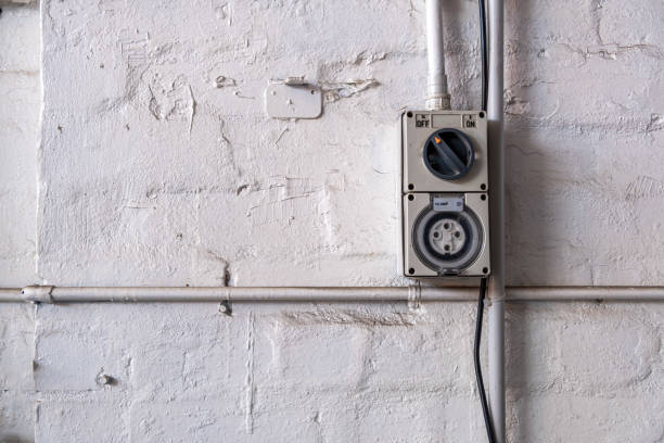 istock Industrial 10 ampere power outlet mounted to a workshop wall with copy space 1200849274