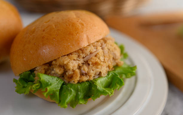 istock Close up appetizing with fish hamburgers and lettuce placed in white dish beautifully, copy space 1200854954