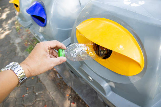 istock A man is bringing a plastic bottle into the trash 1200857449