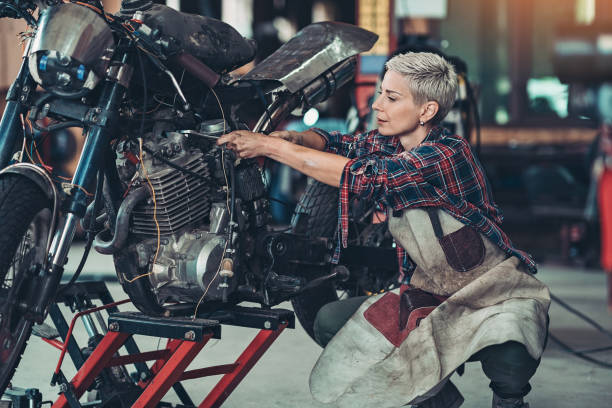 istock Female mechanic repairing a motorcycle'e engine 1200857485