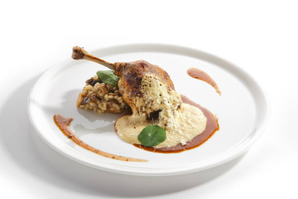 istock Duck Leg Confit with Pearl Barley on Restaurant Plate Isolated 1200859237