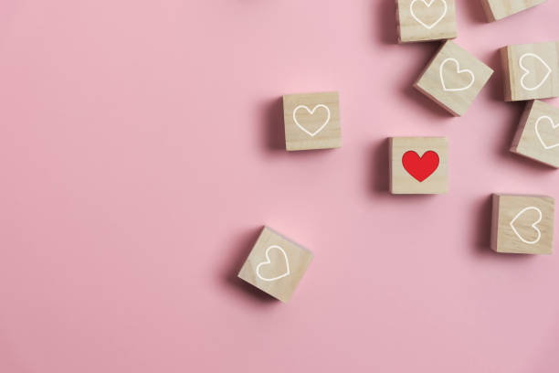 istock Heart in Wooden cubes on pink background. 1200861880