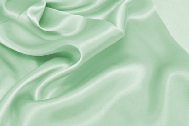istock Draped satin green fabric for festive backgrounds 1200862096