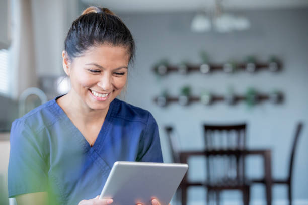 istock Happy nurse or doctor video chatting with patients while working from home 1200862813