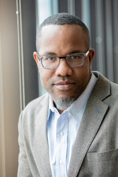 istock Handsome professional African American man smiles while looking at camera 1200863721