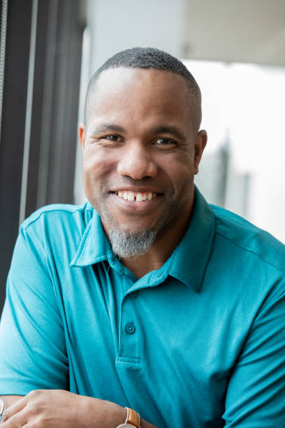 istock Professional man smiles while sitting in front of window 1200863722