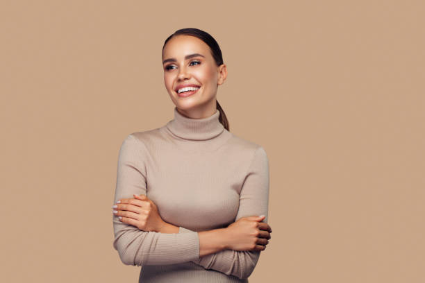 Girl with perfect smile is posing at the studio