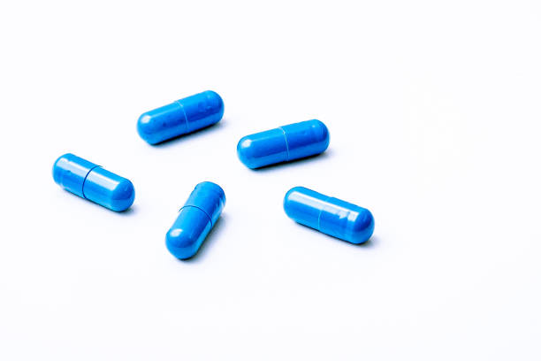 istock Blue capsules representing medicines or food supplements. Studio shot with white background. 1200868534