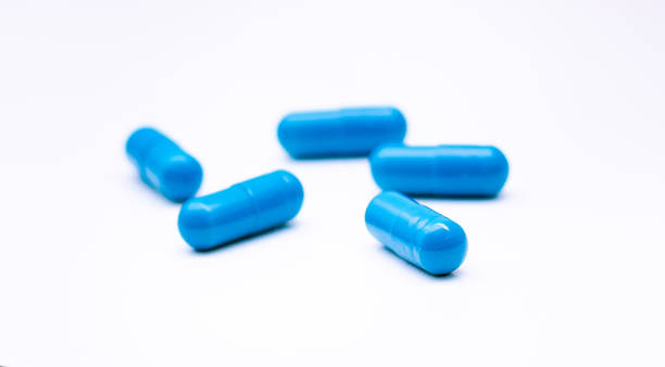 istock Blue capsules representing medicines or food supplements. Studio shot with white background. 1200868551