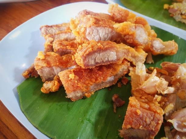 istock Fried pork with garlic on banana leaf - Thai food 1200871104