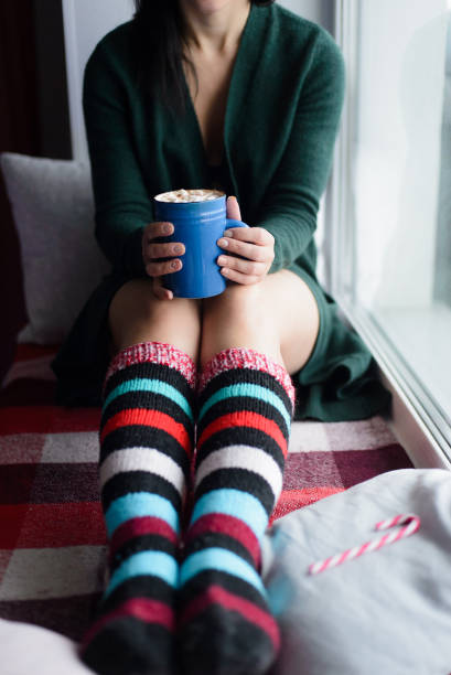 istock woman holding blue cup with cocoa and marshmallow 1200874591