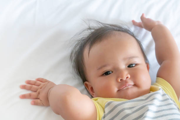 istock Just wake up baby girl under white bed 1200879127
