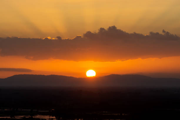 istock Silhouette Mountain and Sunset sky with sun and clouds. 1200879885