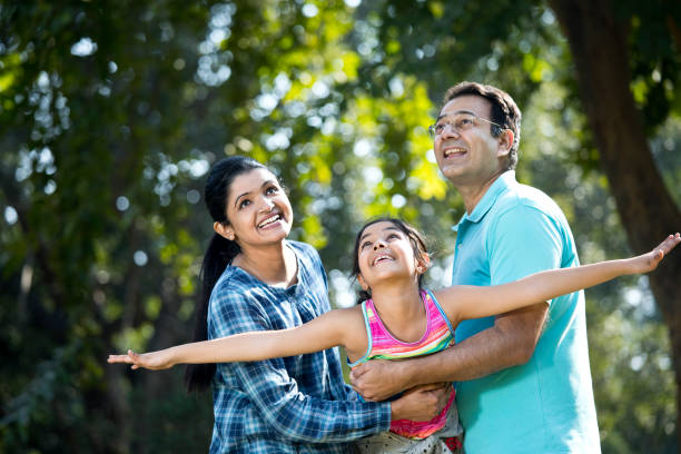 istock Parents lifting daughter and helping her fly 1200883172
