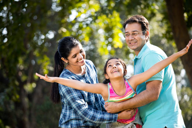 istock Parents lifting daughter and helping her fly 1200883195