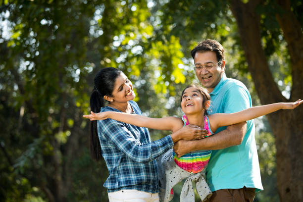 istock Parents lifting daughter and helping her fly 1200883206