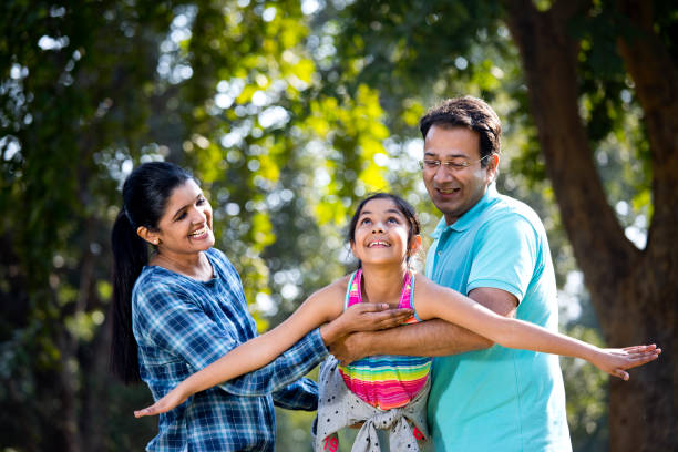 istock Parents lifting daughter and helping her fly 1200883796