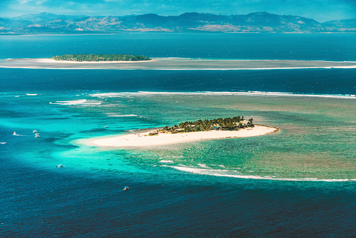 Coral reefs and paradise islands at the Fiji Islands east of Australia seen in the summer in the middle of the pacific Ocean.