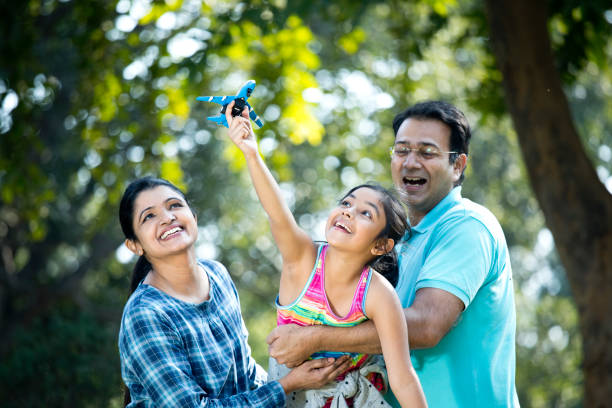 istock Parents with daughter flying toy airplane 1200884821