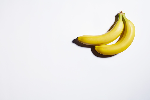 Two ripe bananas on white background