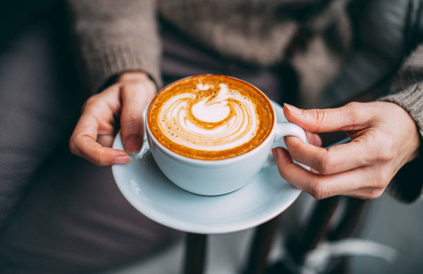 istock Flat Lay Woman Hand Holding Coffee Latte 1200887355