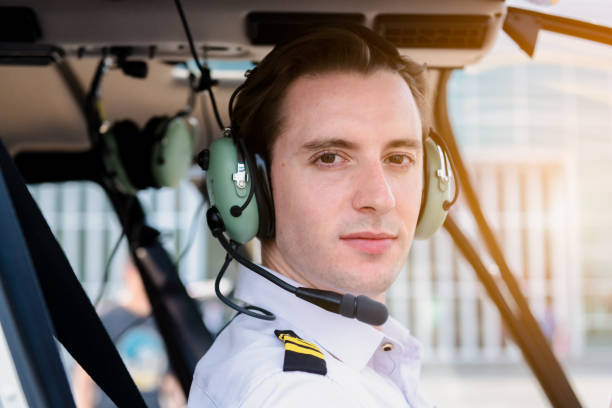 istock A Airline pilot wearing uniform sitting inside with epaulettes and headset to connect with another pilot on board passenger. 1200887569