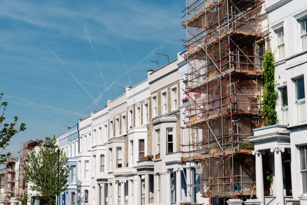 Traditional townhouses in Notting Hill, one of which is being restored Traditional townhouses in Notting Hill, one of which is being renovated, London notting hill photos stock pictures, royalty-free photos & images