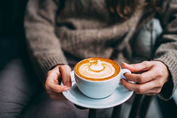 istock Flat Lay Woman Hand Holding Coffee Latte 1200888570