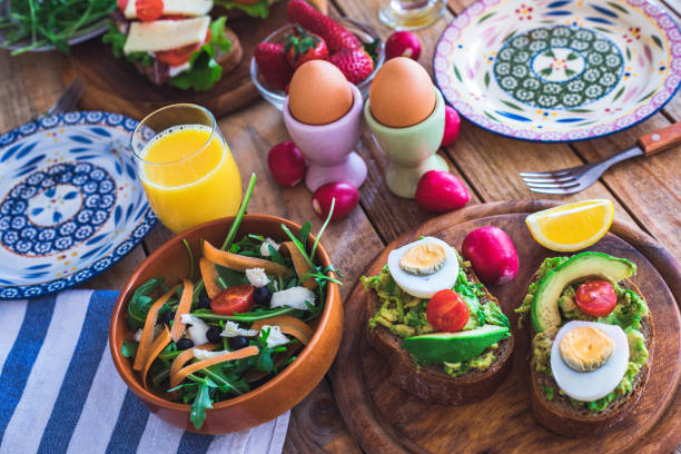 istock Breakfast on table, sandwiches with guacamole, whole avocado, boiled eggs and veggies on table 1200889685