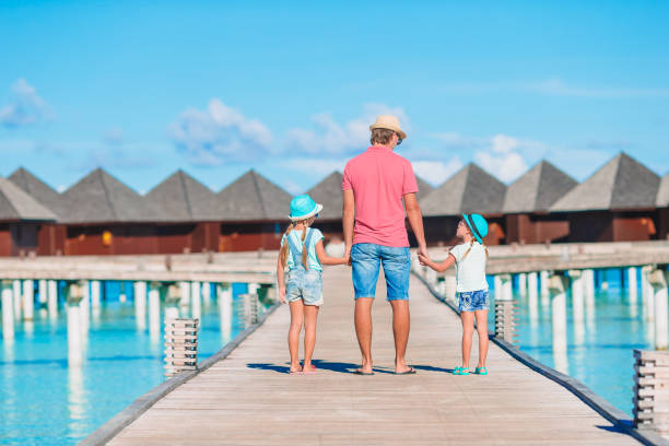istock Father and kids enjoying beach summer vacation 1200889710