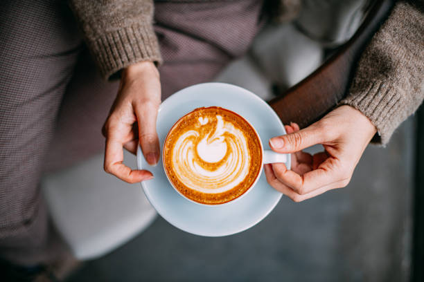 istock Flat Lay Woman Hand Holding Coffee Latte 1200890257