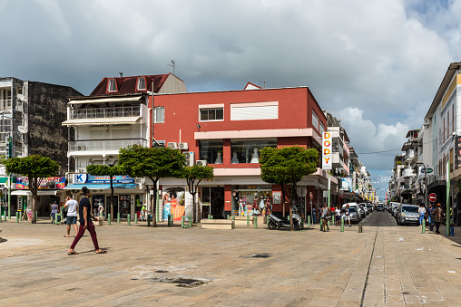 Pointe-a-Pitre, Guadeloupe - December 14, 2018: Street view of Pointe-a-Pitre at day with shops and pedestrians in the French overseas department of Guadeloupe. Caribbean Domestic Life.