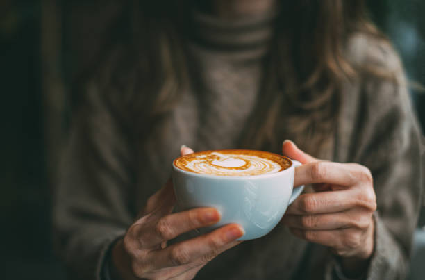 istock Flat Lay Woman Hand Holding Coffee Latte 1200890848