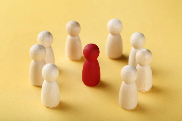 istock Leader concept. Wooden figures on yellow background 1200890858