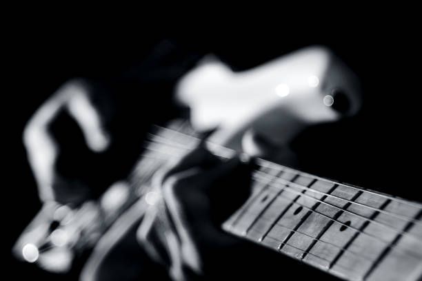 istock Playing guitar. Guitarist plating a solo. Guitar player in monochrome. 1200891106