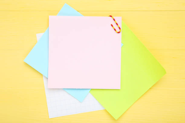 istock Paper sticky notes on yellow wooden table 1200892075