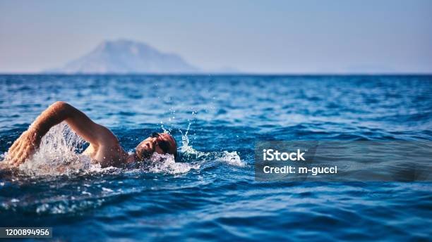 Swimmer Training On The Open Sea Ocean Stock Photo - Download Image Now - Active Lifestyle, Activity, Adult