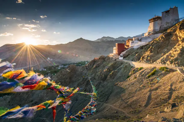 Photo of Prayer flag in Tsemo castle with beautiful mountain snow landscape background in Leh Ladakh