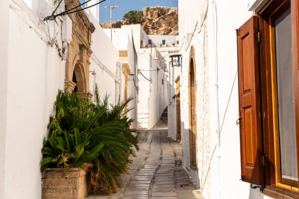 Beautiful street with white buildings in Lindos Greece.