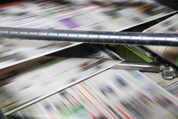 istock Newspaper folding machine in a printing plant 1200901286