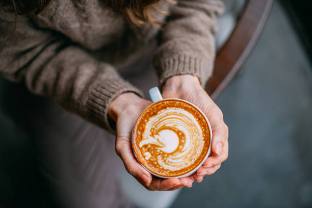 istock Flat Lay Woman Hand Holding Coffee Latte 1200902616