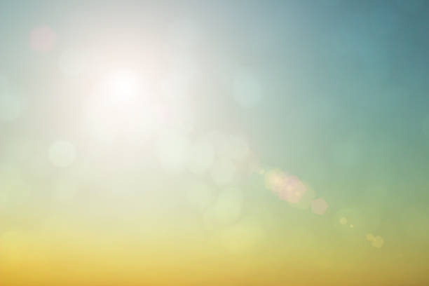 istock Natural background blurring warm colors and bright sun light. Bokeh or Christmas background Green Energy at sky sunny color orange light patterns plain abstract flare evening clouds blur. 1200903316