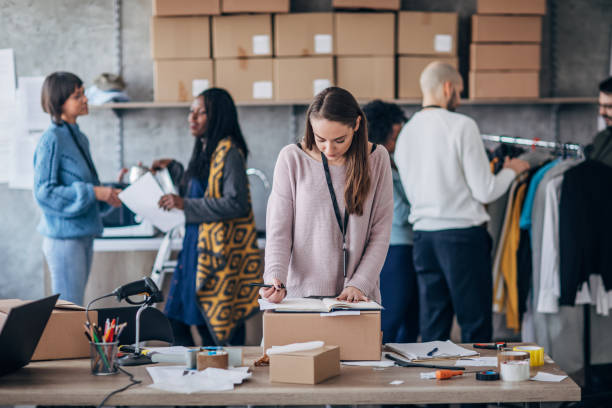 istock Diverse group of people arranging customers orders for drop shipping 1200903646