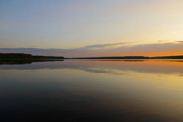istock Summer evening landscape with a lake and forest on the horizon 1200904285